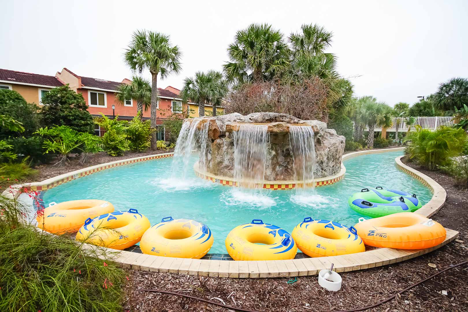 A colorful view of the outdoor lazy river pool at VRI's Fantasy World Resort in Florida.